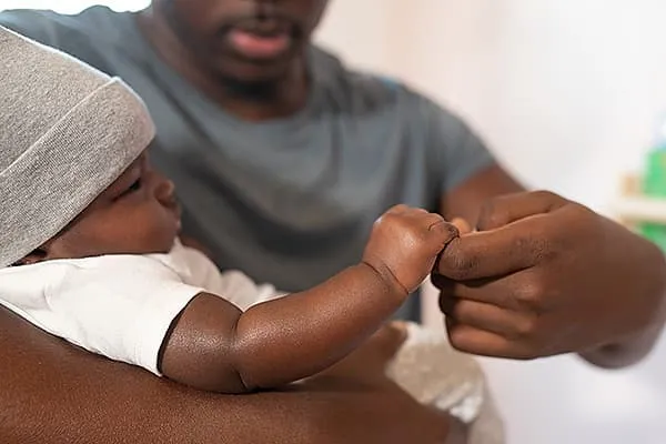 Father interacting with baby during hearing study