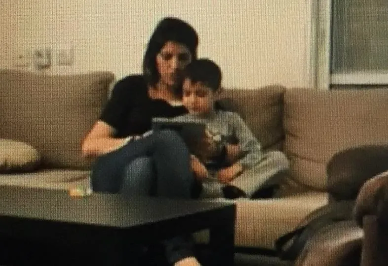 Mother and child side-by-side book reading position