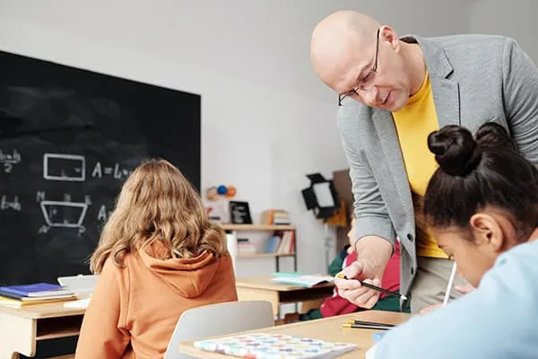 Teacher helping student
