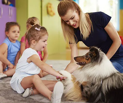 Child interacting with therapy dog